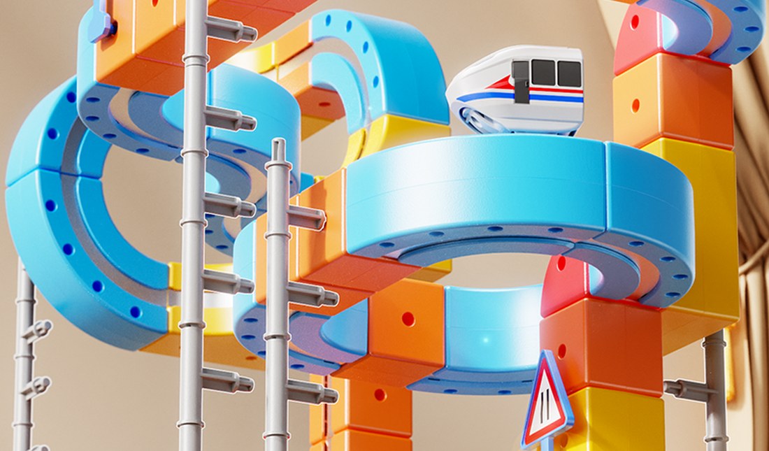 A child's hand building a magnetic track